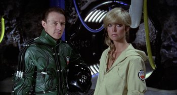 Movie still from “Saturn 3” (1980), directed by John Barry – A man and a woman standing next to each other; Close Up shot, Low angle