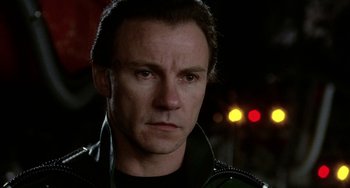 Movie still from “Saturn 3” (1980), directed by John Barry – A person wearing headphones; Close Up shot, Low angle