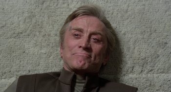 Movie still from “Saturn 3” (1980), directed by John Barry – An older man laying on the ground with his mouth open; Close Up shot, Low angle