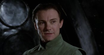 Movie still from “Saturn 3” (1980), directed by John Barry – A person wearing a green shirt; Close Up shot, Low angle