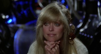 Movie still from “Saturn 3” (1980), directed by John Barry – A person with long blonde hair; Close Up shot, Over the shoulder angle