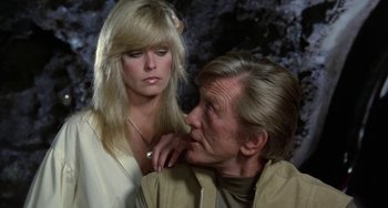Movie still from “Saturn 3” (1980), directed by John Barry – An older man and a young woman looking at each other; Close Up shot, Over the shoulder angle