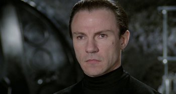 Movie still from “Saturn 3” (1980), directed by John Barry – A person wearing a black shirt; Close Up shot, Low angle