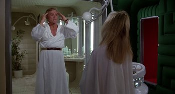 Movie still from “Saturn 3” (1980), directed by John Barry – A man and a woman in a bathroom; Medium shot, Over the shoulder angle