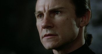 Movie still from “Saturn 3” (1980), directed by John Barry – A man's face in a dark room; Close Up shot, Low angle