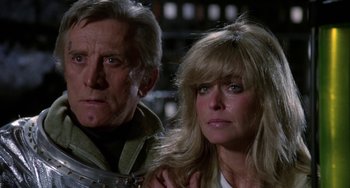 Movie still from “Saturn 3” (1980), directed by John Barry – A man and a woman standing next to each other; Close Up shot, Over the shoulder angle