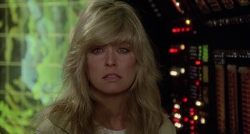 Movie still from “Saturn 3” (1980), directed by John Barry – A person with long blonde hair; Close Up shot, Over the shoulder angle