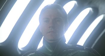 Movie still from “Saturn 3” (1980), directed by John Barry – A person wearing a uniform; Close Up shot, Low angle