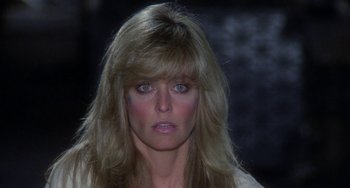 Movie still from “Saturn 3” (1980), directed by John Barry – A person with long blonde hair; Close Up shot, Over the shoulder angle