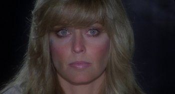 Movie still from “Saturn 3” (1980), directed by John Barry – A person's face with long blonde hair; Close Up shot, Low angle