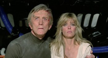 Movie still from “Saturn 3” (1980), directed by John Barry – A man and a woman posing for a picture; Close Up shot, Low angle