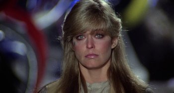 Movie still from “Saturn 3” (1980), directed by John Barry – A person with long blonde hair; Close Up shot, Over the shoulder angle