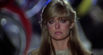 Movie still from “Saturn 3” (1980), directed by John Barry – A person with long blonde hair; Close Up shot, Over the shoulder angle