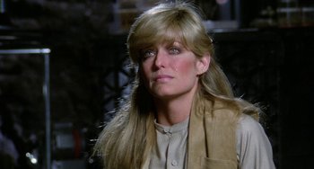 Movie still from “Saturn 3” (1980), directed by John Barry – A person with long blonde hair; Close Up shot, Over the shoulder angle