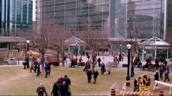 A group of people walking in a park near a building