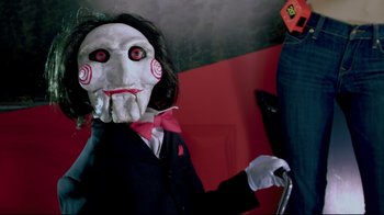 Movie still from “Saw 3D” (2010), directed by Kevin Greutert – A person wearing a mask and holding a cane; Close Up shot, High angle