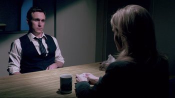 Movie still from “Saw 3D” (2010), directed by Kevin Greutert – A man and a woman are sitting at a table; Medium shot, Over the shoulder angle