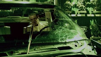 Movie still from “Saw 3D” (2010), directed by Kevin Greutert – A man is looking out of a broken windshield; Medium shot, High angle
