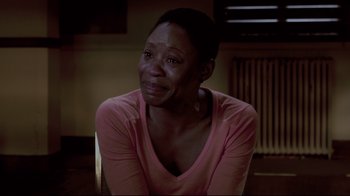 Movie still from “Saw 3D” (2010), directed by Kevin Greutert – A woman sitting in front of a window with her eyes closed; Close Up shot, High angle