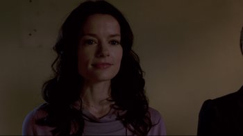 Movie still from “Saw 3D” (2010), directed by Kevin Greutert – A woman with long dark hair wearing a purple shirt; Close Up shot, Over the shoulder angle