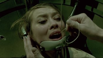 Movie still from “Saw 3D” (2010), directed by Kevin Greutert – A woman is having her teeth examined by a dentist; Close Up shot, Overhead angle
