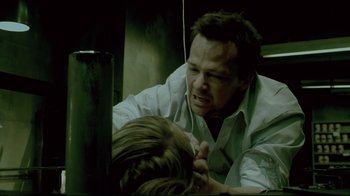 Movie still from “Saw 3D” (2010), directed by Kevin Greutert – A man in a white shirt is wrestling a woman; Close Up shot, Over the shoulder angle