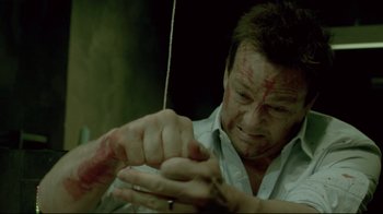 Movie still from “Saw 3D” (2010), directed by Kevin Greutert – A man with blood on his face holding a bow and arrow; Close Up shot, High angle