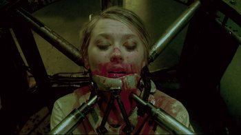 Movie still from “Saw 3D” (2010), directed by Kevin Greutert – A woman is tied up and covered in blood; Close Up shot, Overhead angle