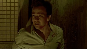 Movie still from “Saw 3D” (2010), directed by Kevin Greutert – A man in a white button up shirt with blood all over his face; Close Up shot, Low angle