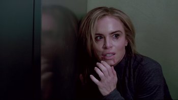 Movie still from “Saw 3D” (2010), directed by Kevin Greutert – A woman with her hand on her face looking into a mirror; Close Up shot, High angle