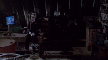 A person wearing a mask sitting in a room