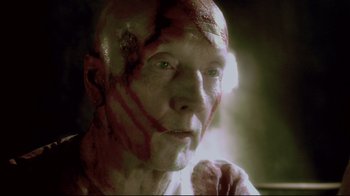 Movie still from “Saw 3D” (2010), directed by Kevin Greutert – A person with blood all over his face; Close Up shot, Overhead angle