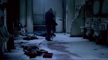 Movie still from “Saw 3D” (2010), directed by Kevin Greutert – A group of people laying on the ground in a room; Wide shot, High angle