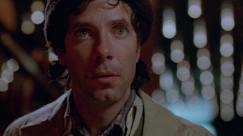 Movie still from “Scanners” (1981), directed by David Cronenberg – A person wearing a jacket; Close Up shot, Over the shoulder angle