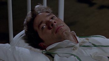 Movie still from “Scanners” (1981), directed by David Cronenberg – A person laying in a hospital bed; Close Up shot, High angle