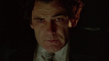 Movie still from “Scanners” (1981), directed by David Cronenberg – A person wearing a suit and tie; Close Up shot, Low angle