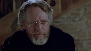 Movie still from “Scanners” (1981), directed by David Cronenberg – An older man with a beard and glasses; Close Up shot, Over the shoulder angle