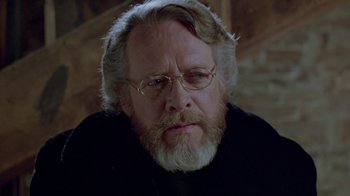 Movie still from “Scanners” (1981), directed by David Cronenberg – An older man with a beard and glasses; Close Up shot, Over the shoulder angle