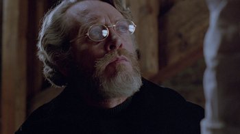 Movie still from “Scanners” (1981), directed by David Cronenberg – An old man with a beard and glasses looking to his left; Close Up shot, Low angle