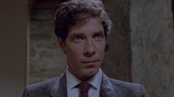 Movie still from “Scanners” (1981), directed by David Cronenberg – A man in a suit and a tie; Close Up shot, Over the shoulder angle