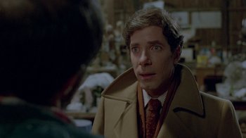 Movie still from “Scanners” (1981), directed by David Cronenberg – A man wearing a suit and tie in front of another man; Close Up shot, Over the shoulder angle