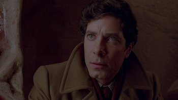 Movie still from “Scanners” (1981), directed by David Cronenberg – A person wearing a coat; Close Up shot, Over the shoulder angle