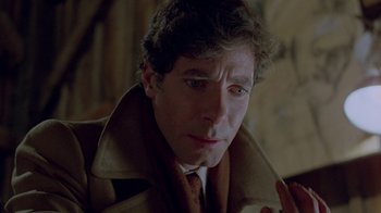 Movie still from “Scanners” (1981), directed by David Cronenberg – A person wearing a coat and tie; Close Up shot, Over the shoulder angle