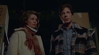 Movie still from “Scanners” (1981), directed by David Cronenberg – A man and a woman standing next to each other; Medium shot, Low angle