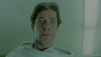 Movie still from “Scanners” (1981), directed by David Cronenberg – A person wearing a suit; Close Up shot, Low angle