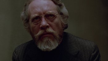 Movie still from “Scanners” (1981), directed by David Cronenberg – An older man with a beard and glasses; Close Up shot, Over the shoulder angle