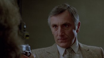 Movie still from “Scanners” (1981), directed by David Cronenberg – A person holding a camera; Close Up shot, Low angle