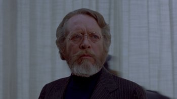 Movie still from “Scanners” (1981), directed by David Cronenberg – An older man with a beard and glasses; Close Up shot, Low angle