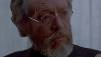 Movie still from “Scanners” (1981), directed by David Cronenberg – An older man with a beard and glasses; Close Up shot, Over the shoulder angle