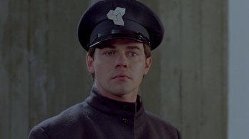 Movie still from “Scanners” (1981), directed by David Cronenberg – A man wearing a uniform and a hat; Close Up shot, Low angle